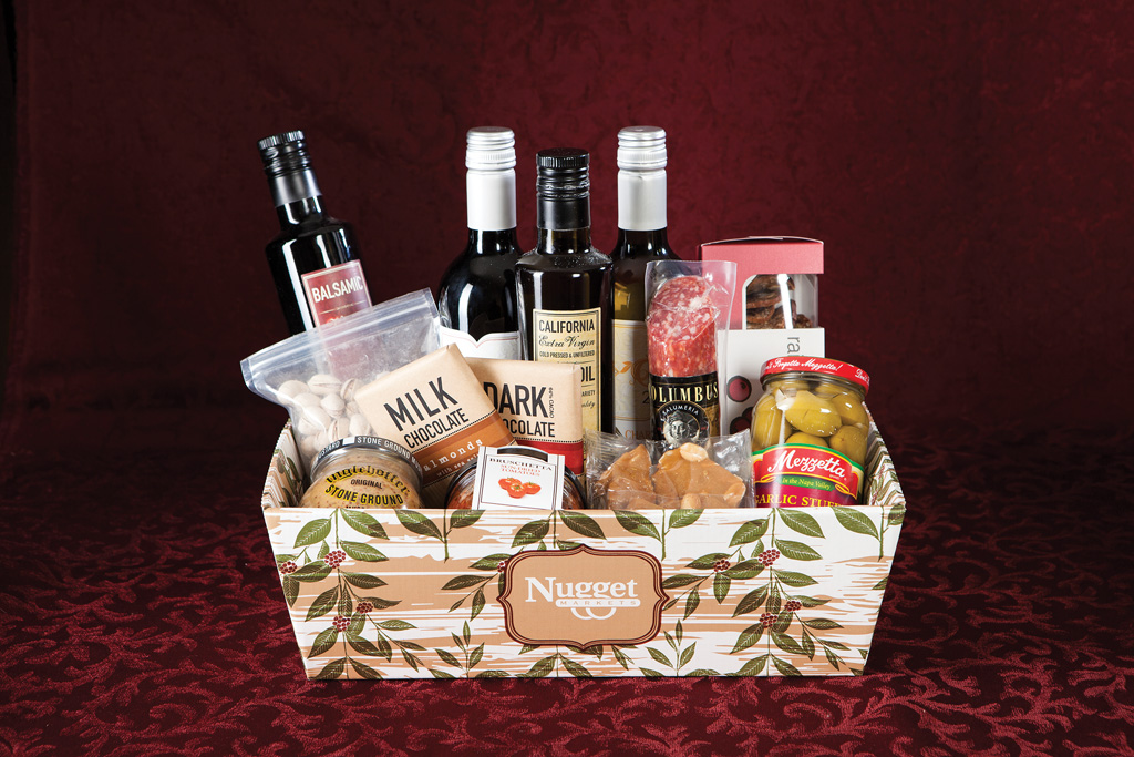 Wine Gift Basket The Wine Basket includes salami, crackers, wine (or sparkling cider, if you prefer), Fresh to Market Extra Virgin Olive Oil and Balsamic Vinegar, Fresh to Market chocolate, olives and nuts.
